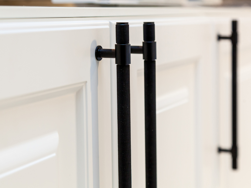 Modern black kitchen cabinet handles on white doors
