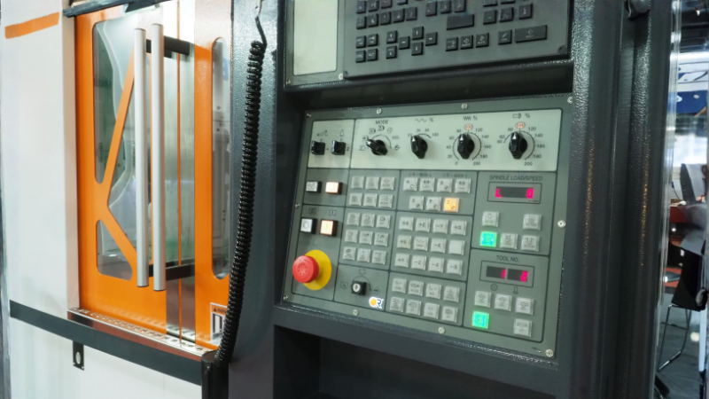 a CNC machine control panel inside an industrial workshop